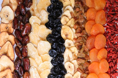 Photo of Different tasty dried fruits as background, top view