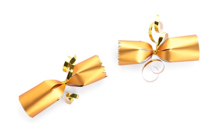 Open shiny golden Christmas cracker isolated on white, top view