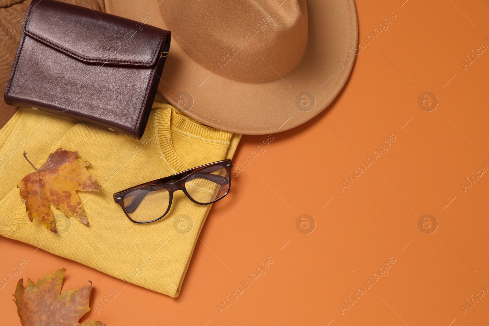 Photo of Flat lay composition with stylish hat on orange background, space for text