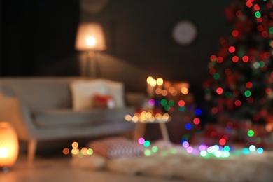 Photo of Blurred view of stylish room interior with decorated Christmas tree