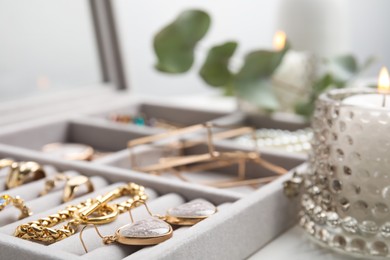 Elegant jewelry box with beautiful bijouterie on table, closeup