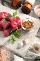 Photo of Raw beef meat and different ingredients for cooking delicious goulash on table
