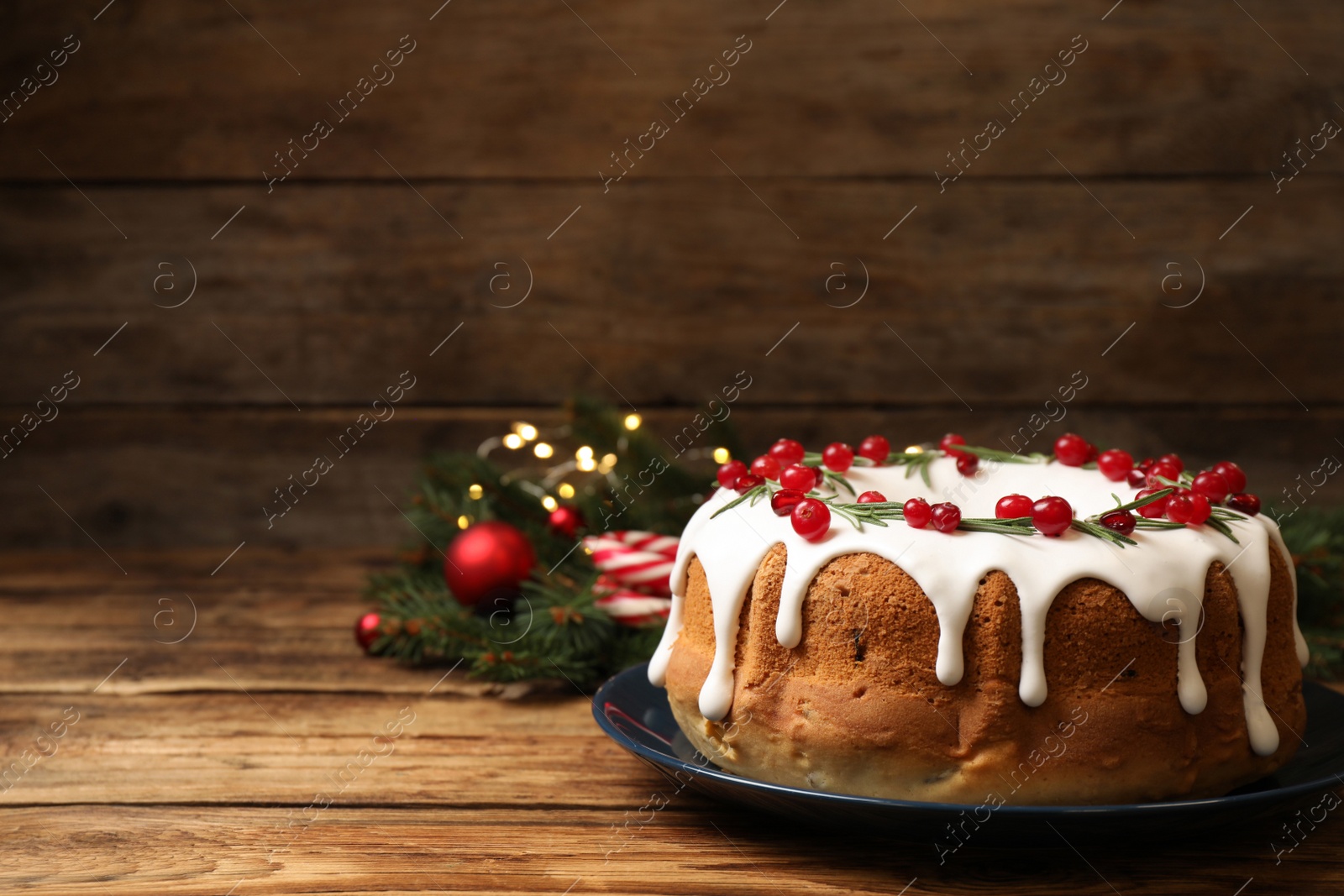 Photo of Traditional homemade Christmas cake on wooden table, space for text