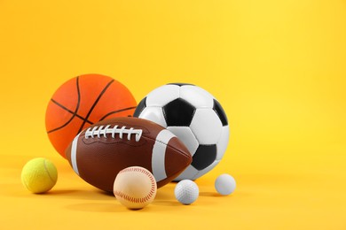 Many different sports balls on yellow background, space for text