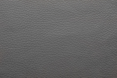 Texture of dark leather as background, closeup