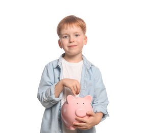 Photo of Cute little boy with ceramic piggy bank on white background