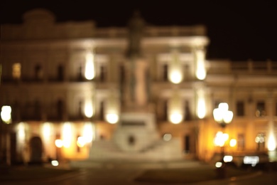 Photo of Blurred view of street with lights at night. Bokeh effect