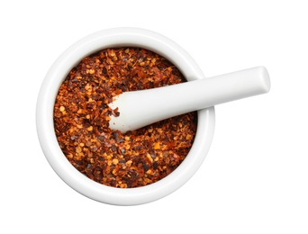 Mortar with crushed chili pepper on white background