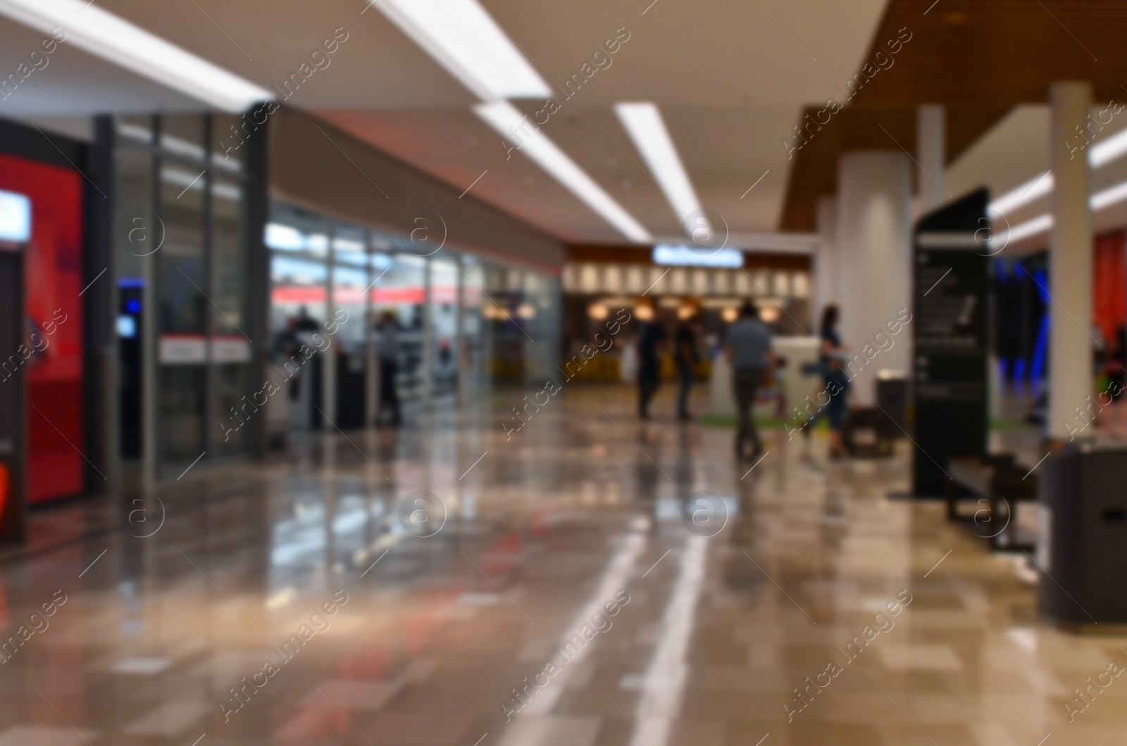 Photo of Blurred view of big shopping mall with many stores