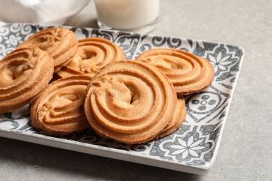 Plate with Danish butter cookies on table