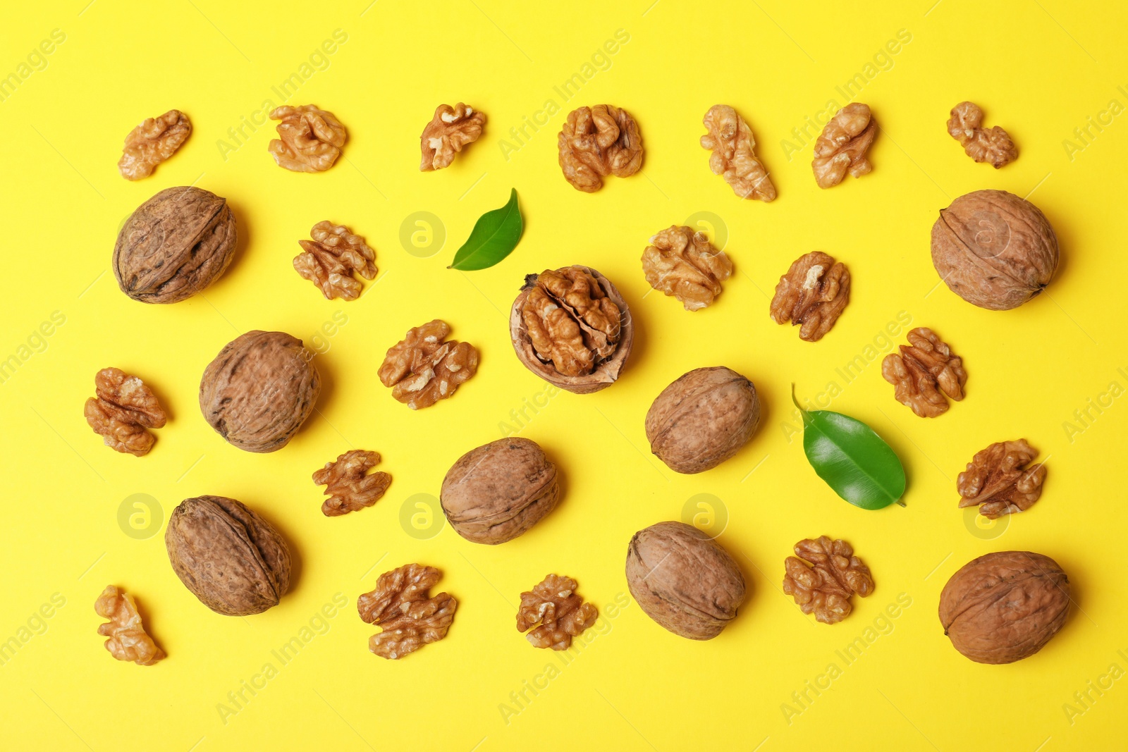 Photo of Flat lay composition with walnuts on color background