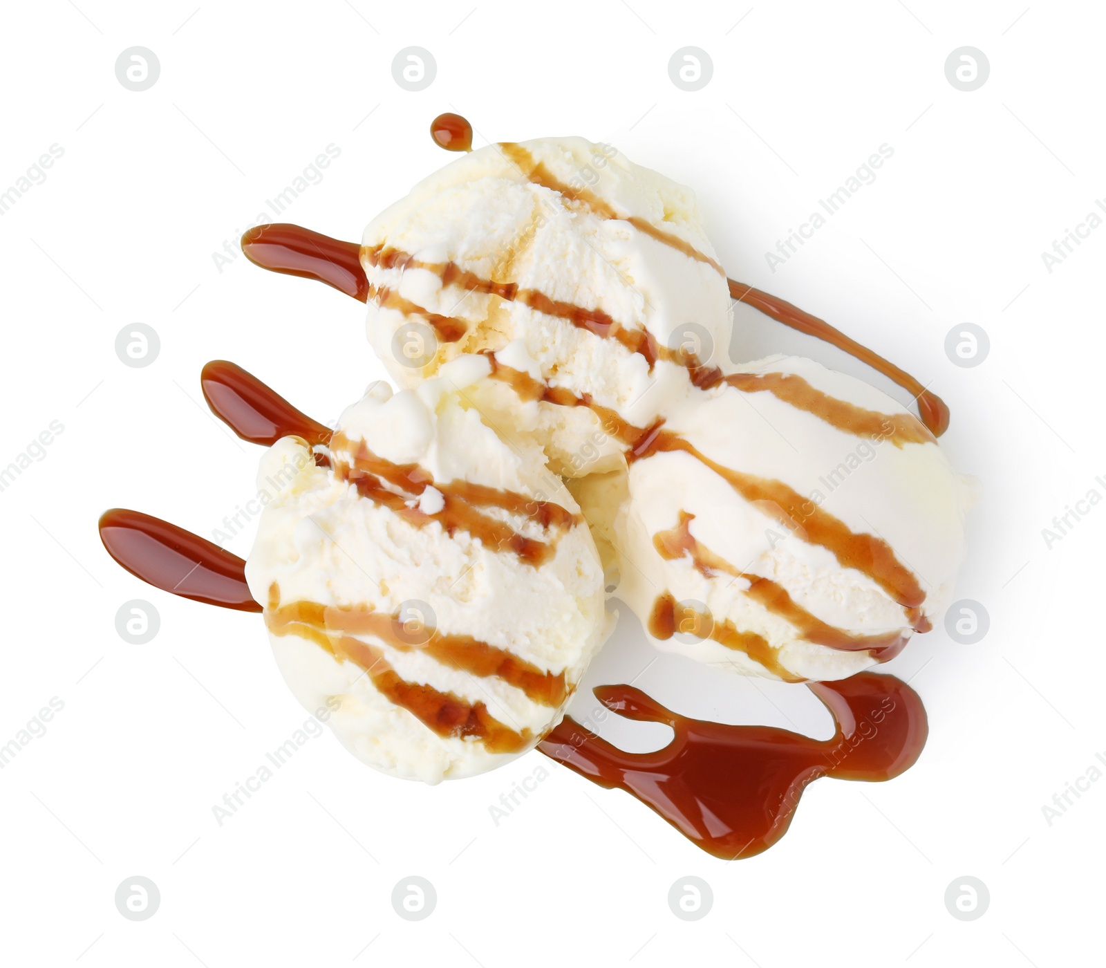 Photo of Scoops of ice cream with caramel sauce isolated on white, top view