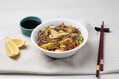 Photo of Stir-fry. Delicious cooked noodles with chicken and vegetables in bowl served on table