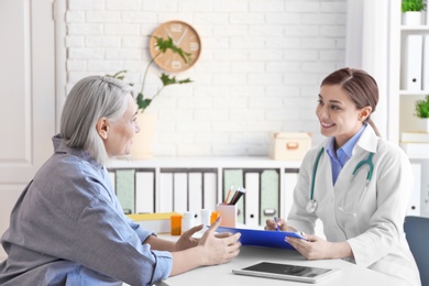 Photo of Female doctor consulting patient in clinic