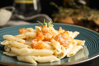 Photo of Delicious pasta with shrimps on table, closeup