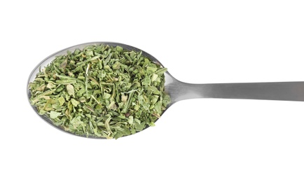 Spoon with dried parsley on white background, top view