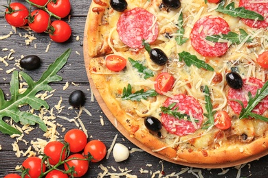 Photo of Flat lay composition with delicious pizza and ingredients on table