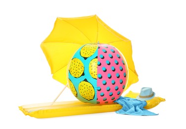 Photo of Open yellow beach umbrella, inflatable ring, mattress, towel and hat on white background
