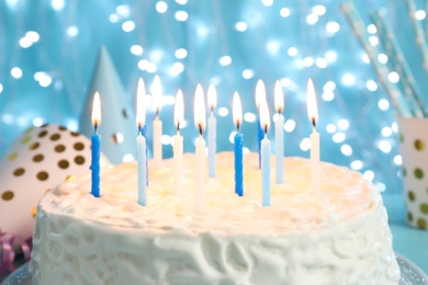 Photo of Delicious birthday cake with burning candles, closeup