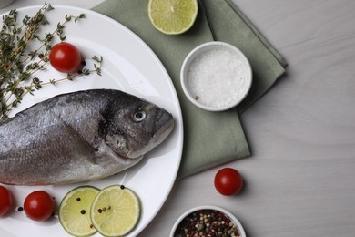 Photo of Flat lay composition with raw dorado fish and spices on white wooden table
