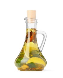 Photo of Glass jug of cooking oil with spices and herbs isolated on white