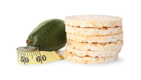 Photo of Healthy diet. Stack of puffed rice cakes, avocado and measuring tape isolated on white