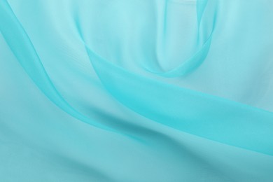 Photo of Beautiful turquoise tulle fabric as background, closeup