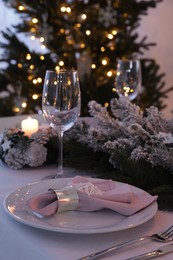 Photo of Beautiful festive place setting with Christmas decor on table indoors
