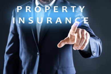 Image of Property insurance concept. Man using virtual screen, closeup
