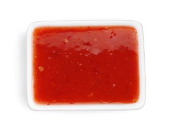 Photo of Spicy chili sauce in bowl isolated on white, top view