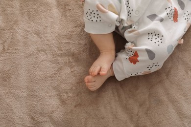 Photo of Little baby on brown blanket, top view. Space for text
