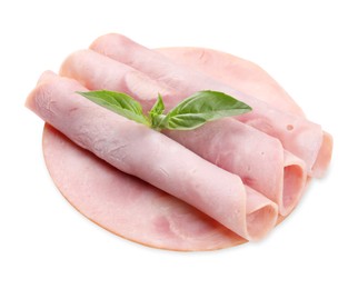 Photo of Rolled slices of tasty ham and basil isolated on white