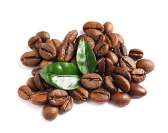 Photo of Roasted coffee beans and fresh green leaves on white background