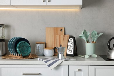 Photo of Set of different utensils and dishes on countertop in kitchen