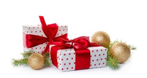 Photo of Composition with Christmas tree branches, festive decor and gift boxes on white background