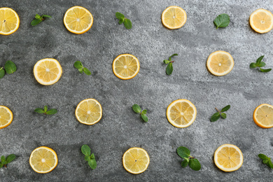 Photo of Lemonade layout with juicy lemon slices and mint on grey table, top view
