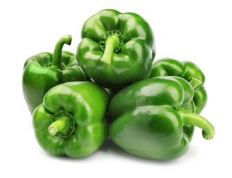 Photo of Pile of tasty green bell peppers on white background