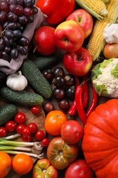 Photo of Different fresh ripe vegetables and fruits on wooden table, flat lay