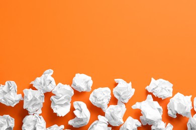 Photo of Crumpled sheets of paper on orange background, flat lay. Space for text