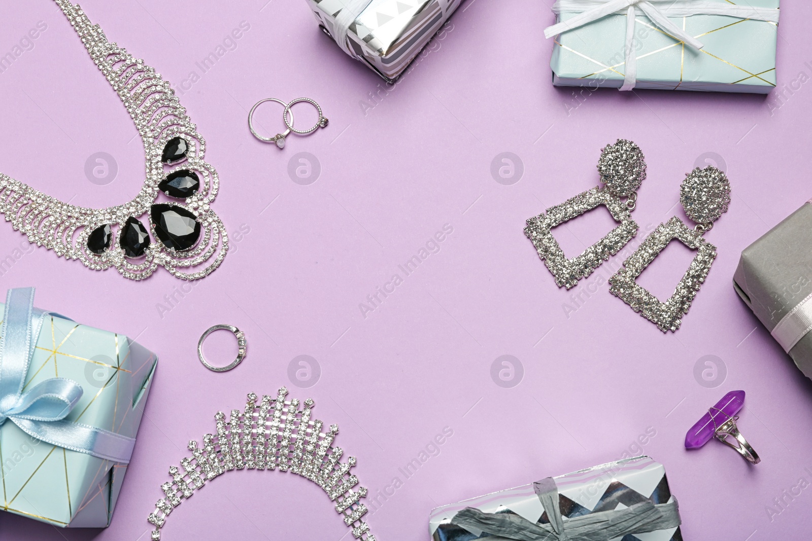 Photo of Beautiful jewelry and gift boxes on color background, flat lay. Space for text