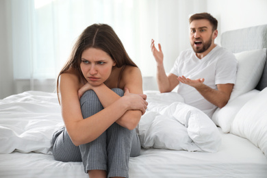 Photo of Unhappy young couple quarreling at home. Relationship problems
