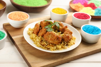 Photo of Traditional Indian food and color powders on white wooden table. Holi festival celebration