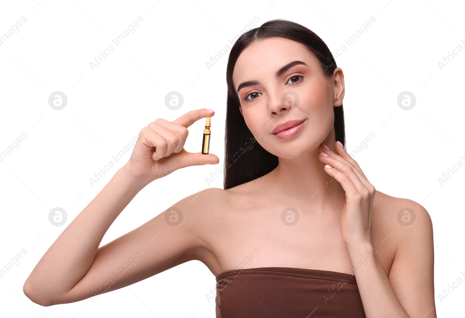 Photo of Beautiful young woman holding skincare ampoule on white background