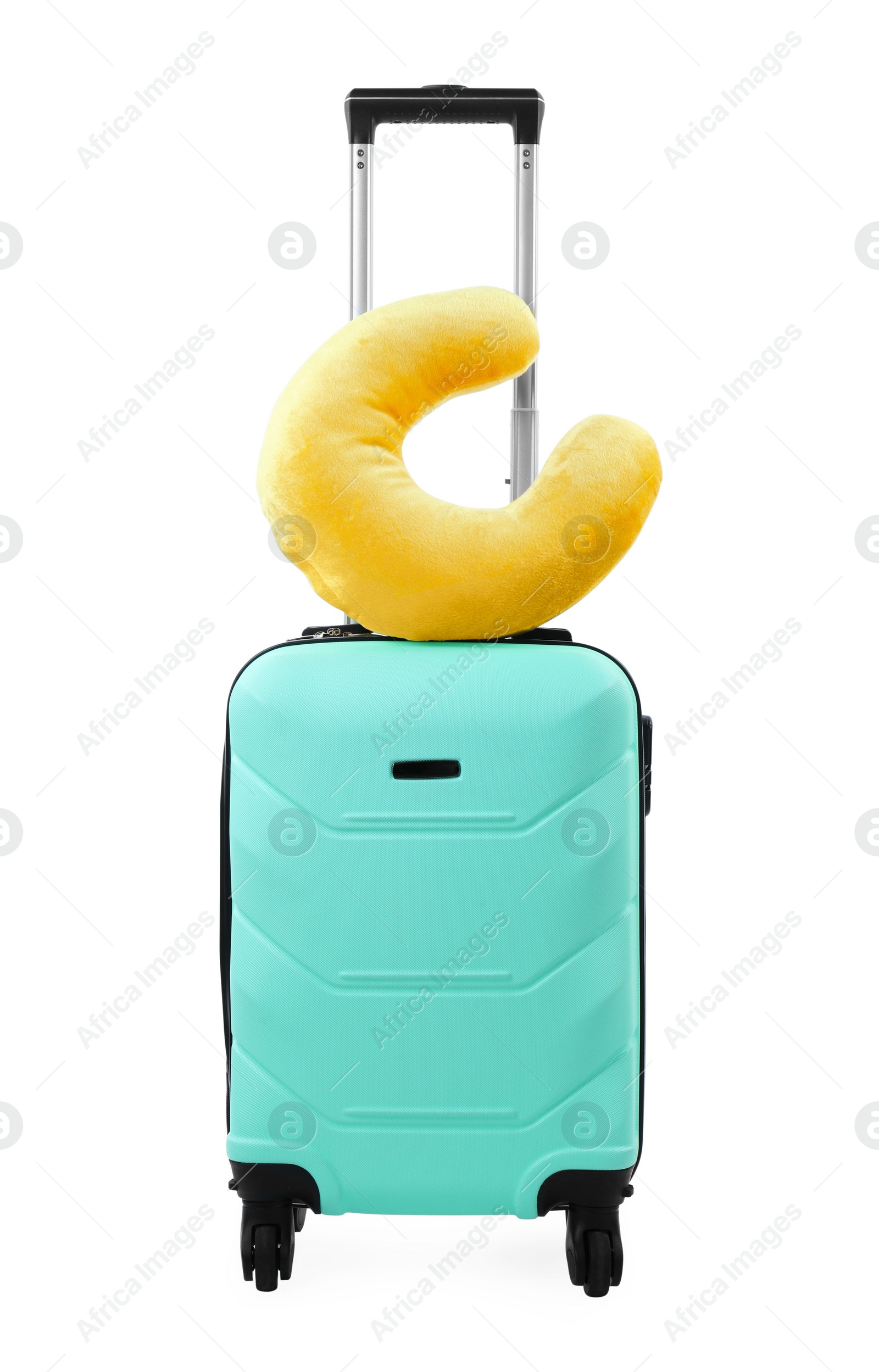 Photo of Soft travel pillow on turquoise suitcase isolated on white