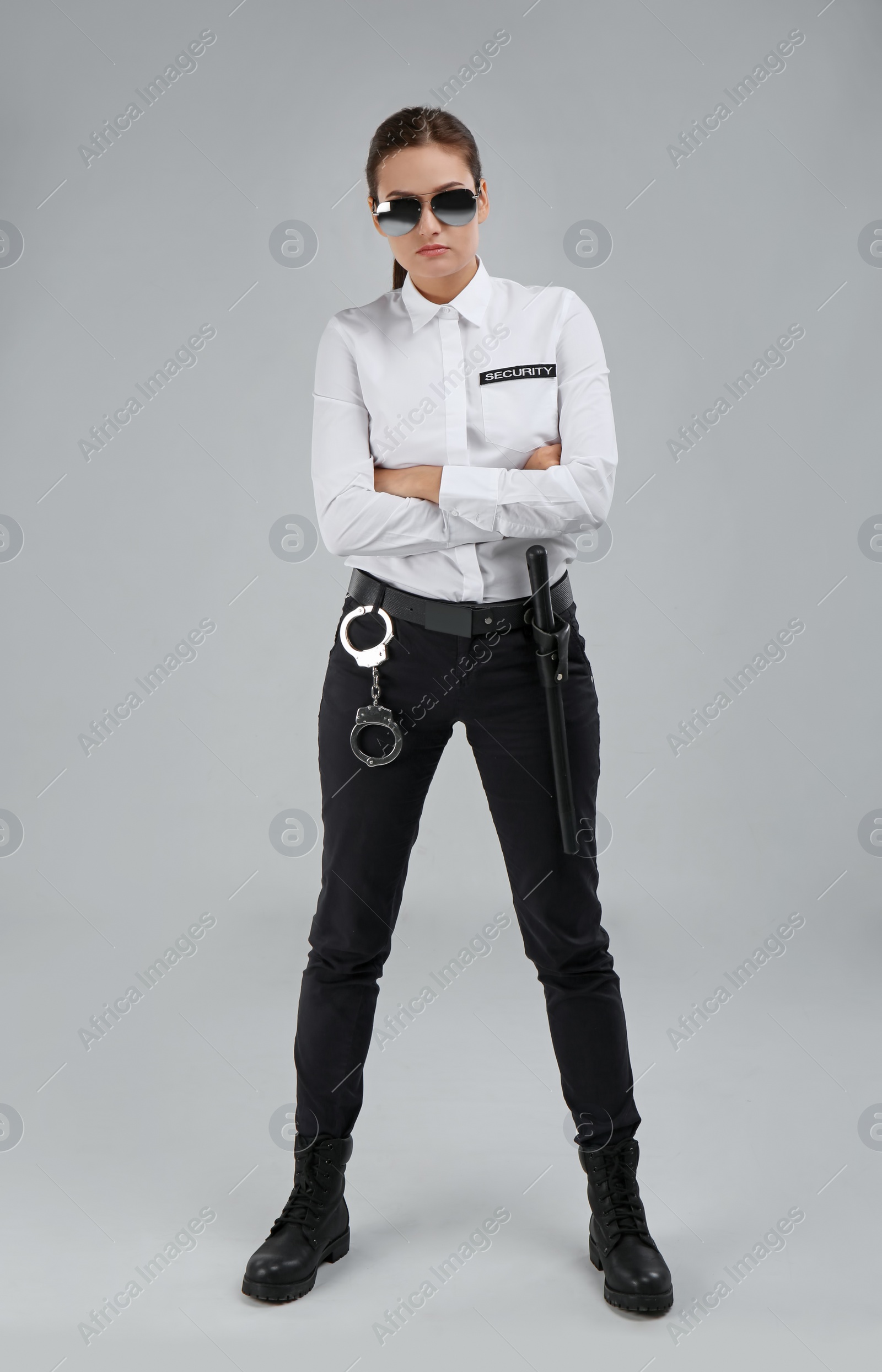 Photo of Female security guard in uniform on color background