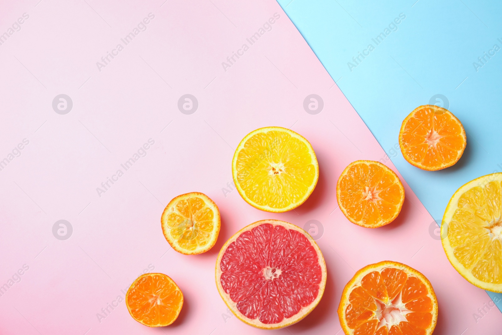 Photo of Different citrus fruits on color background, flat lay. Space for text