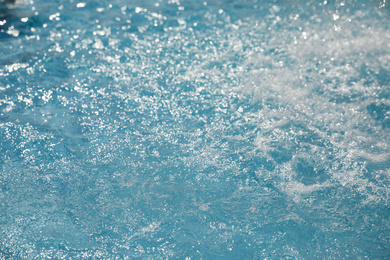 Photo of Splashes in swimming pool on sunny day. Summer vacation