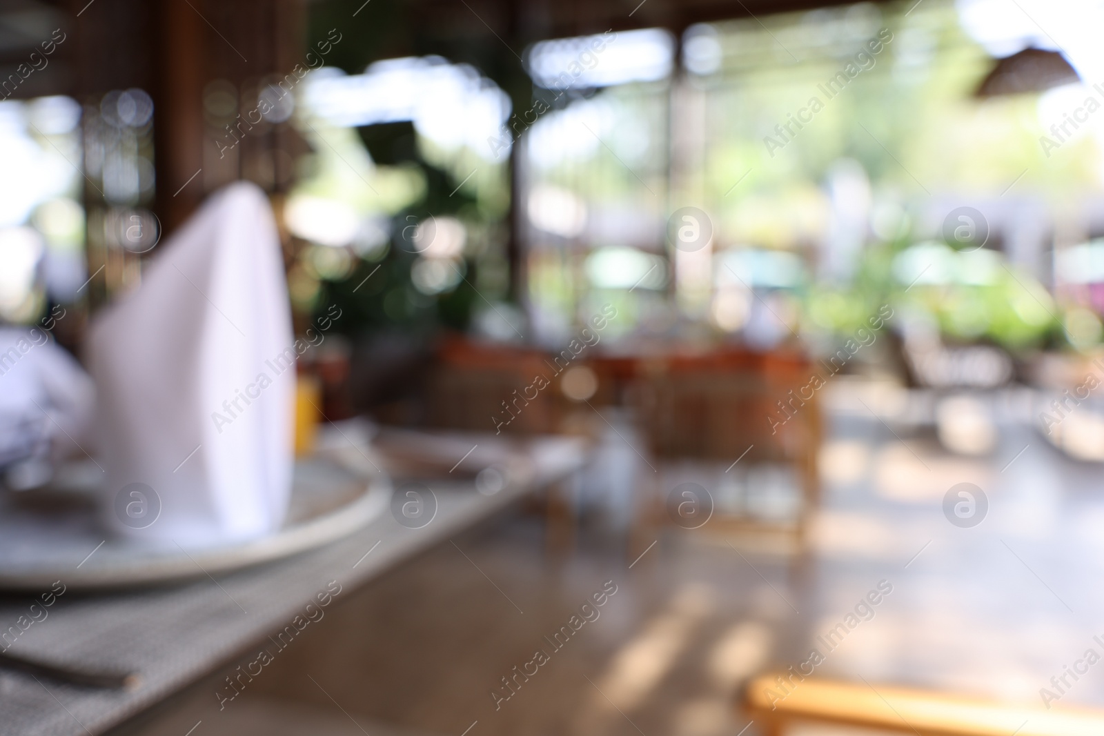 Photo of Blurred view of comfortable cafeteria with furniture