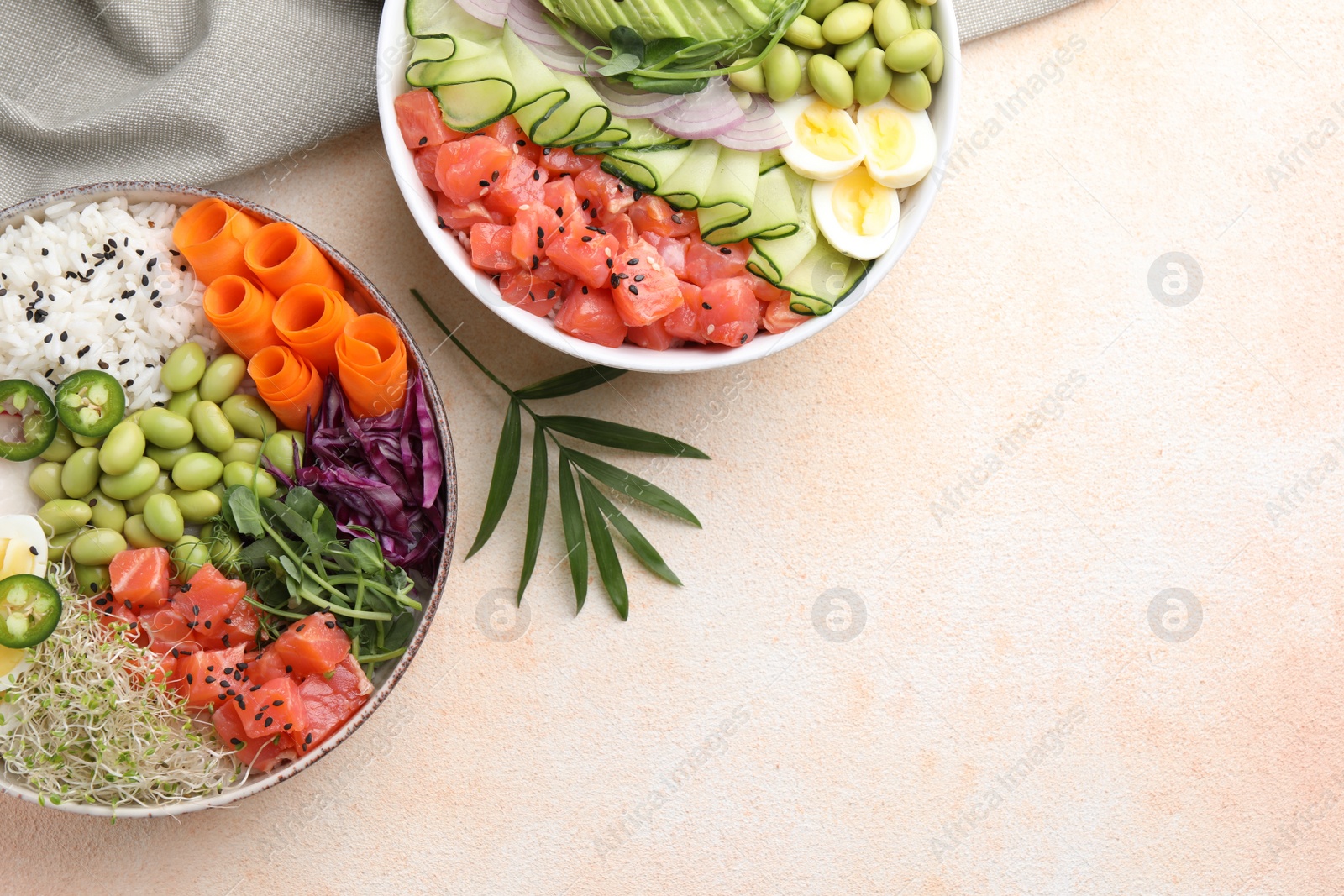 Photo of Delicious poke bowls with vegetables, fish and edamame beans on light table, flat lay. Space for text