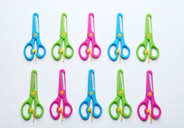 Photo of Set of training scissors on white background, top view